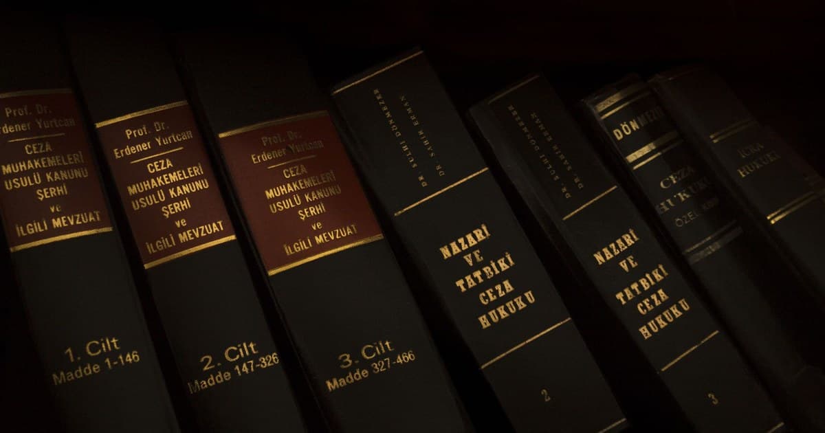 Stack of legal and literature books in a library showcasing various volumes.